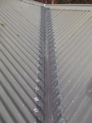 Gutter guard installed in a valley on a corrugated iron roof