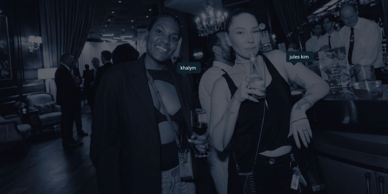 Two women enjoying drinks at a social event.