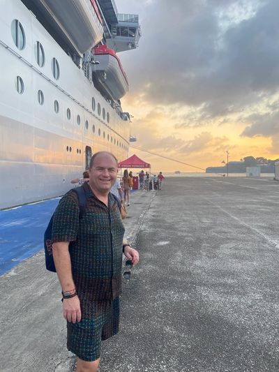 John Keith in front of cruise ship in port