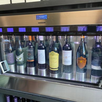 A wine dispensing machine with various bottles displayed.