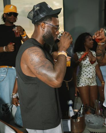 Man drinking at a party.