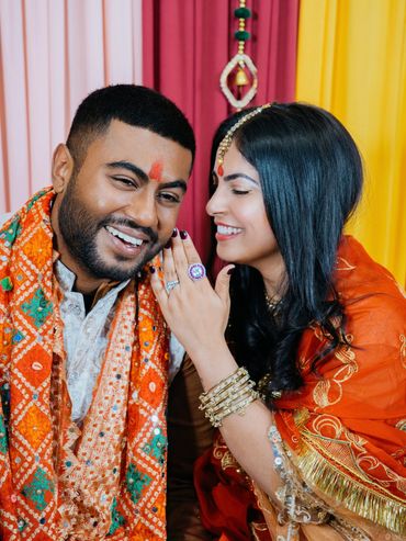 Happy couple in traditional attire smiling joyfully.