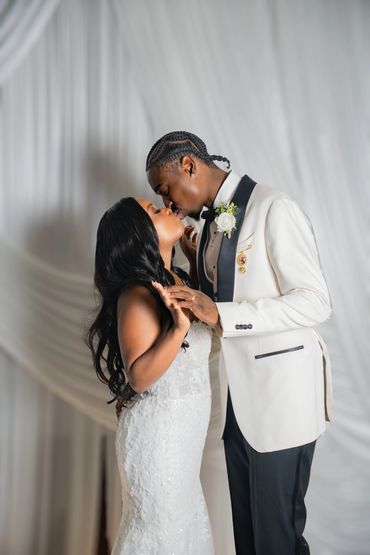Bride and groom sharing a kiss at their wedding.