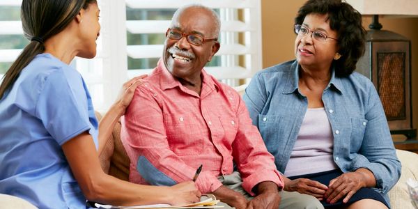 In home health care provider meeting with an elderly resident
