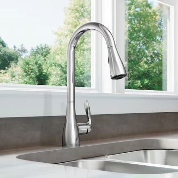 Modern stainless steel kitchen faucet with a high arc.