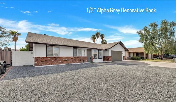 Single-story house with a large front yard covered in grey decorative rock.