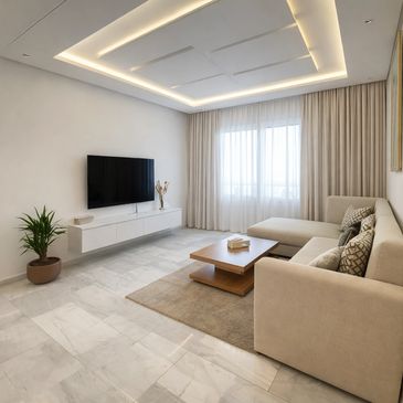 Modern living room with beige sofa and wall-mounted TV.