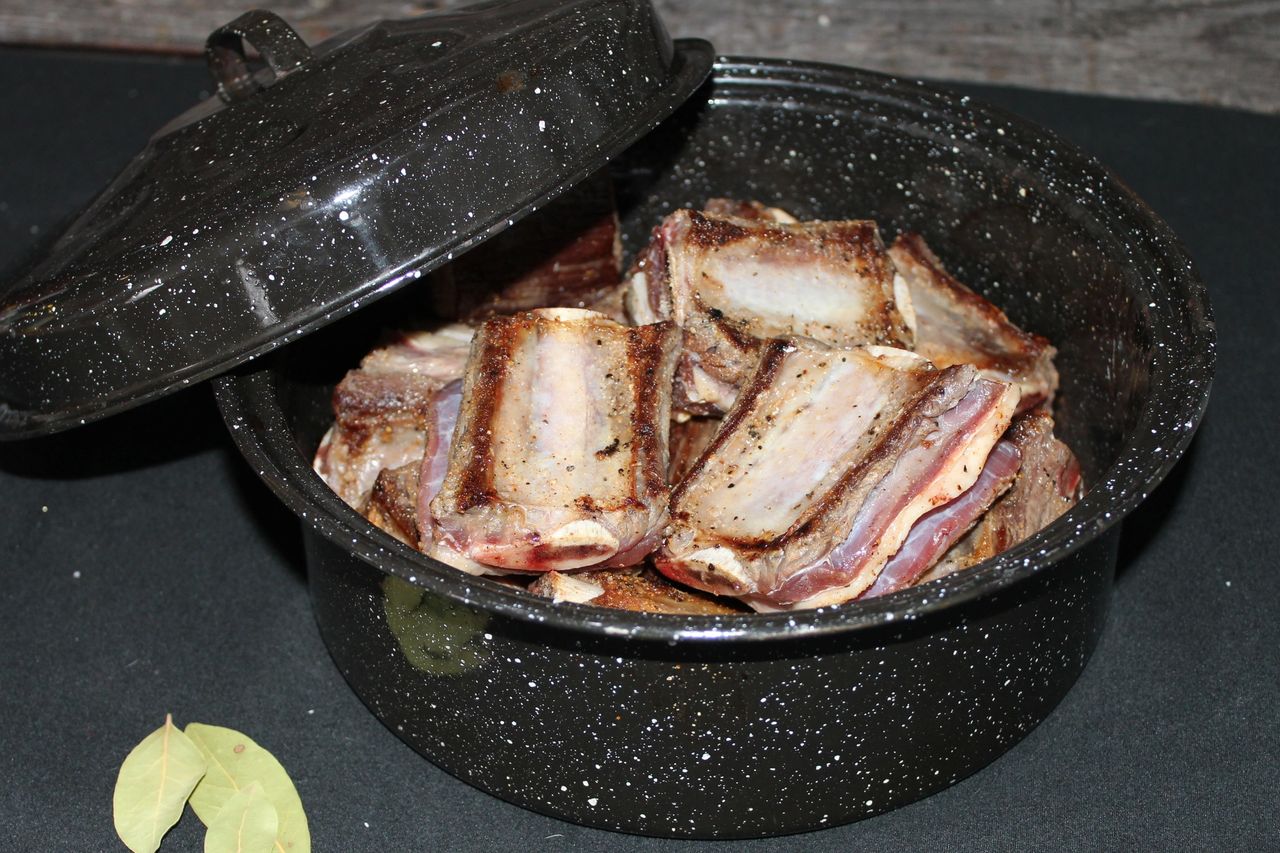 Seared bison short ribs in a roasting pan