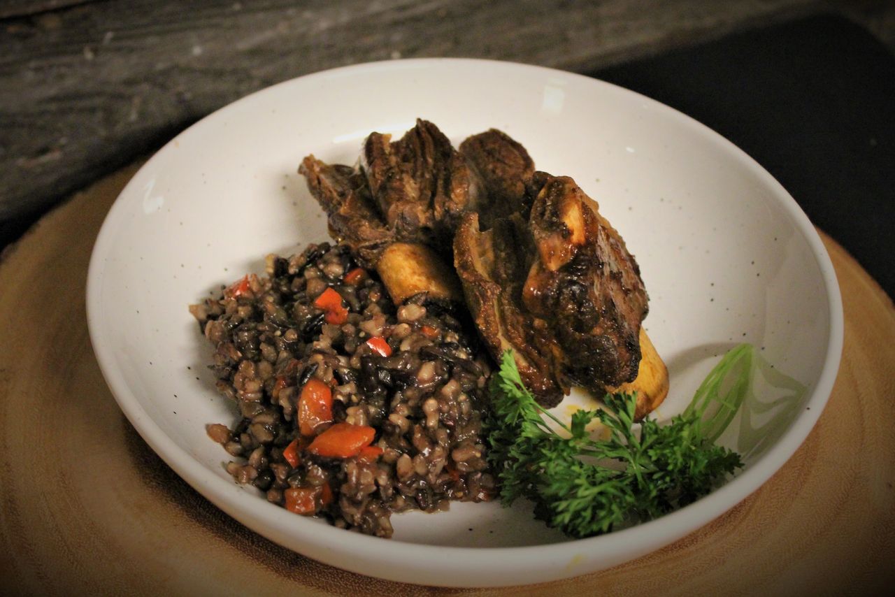 Glazed bison short ribs over a bed of rice and vegetables