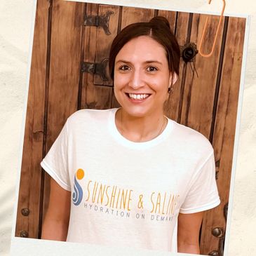 Smiling woman in a white T-shirt with a hydration brand logo.