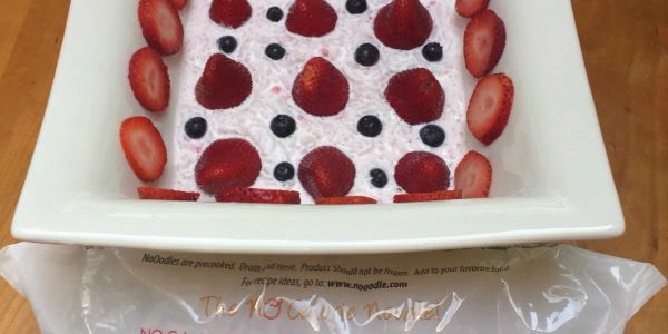 Berry dessert with strawberries and blueberries on white plate.