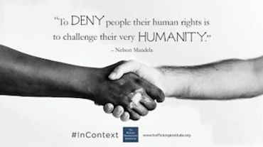 Two hands of different skin tones shaking, symbolizing unity and human rights.