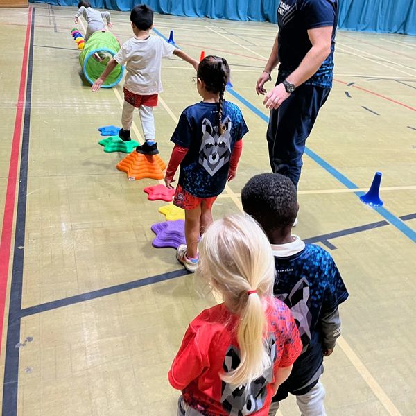 Ballin Out children lining up for obstacle course and balancing