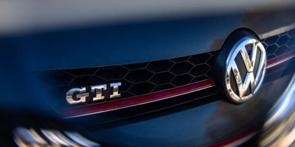 Close-up of Volkswagen GTI emblem on a car grille.