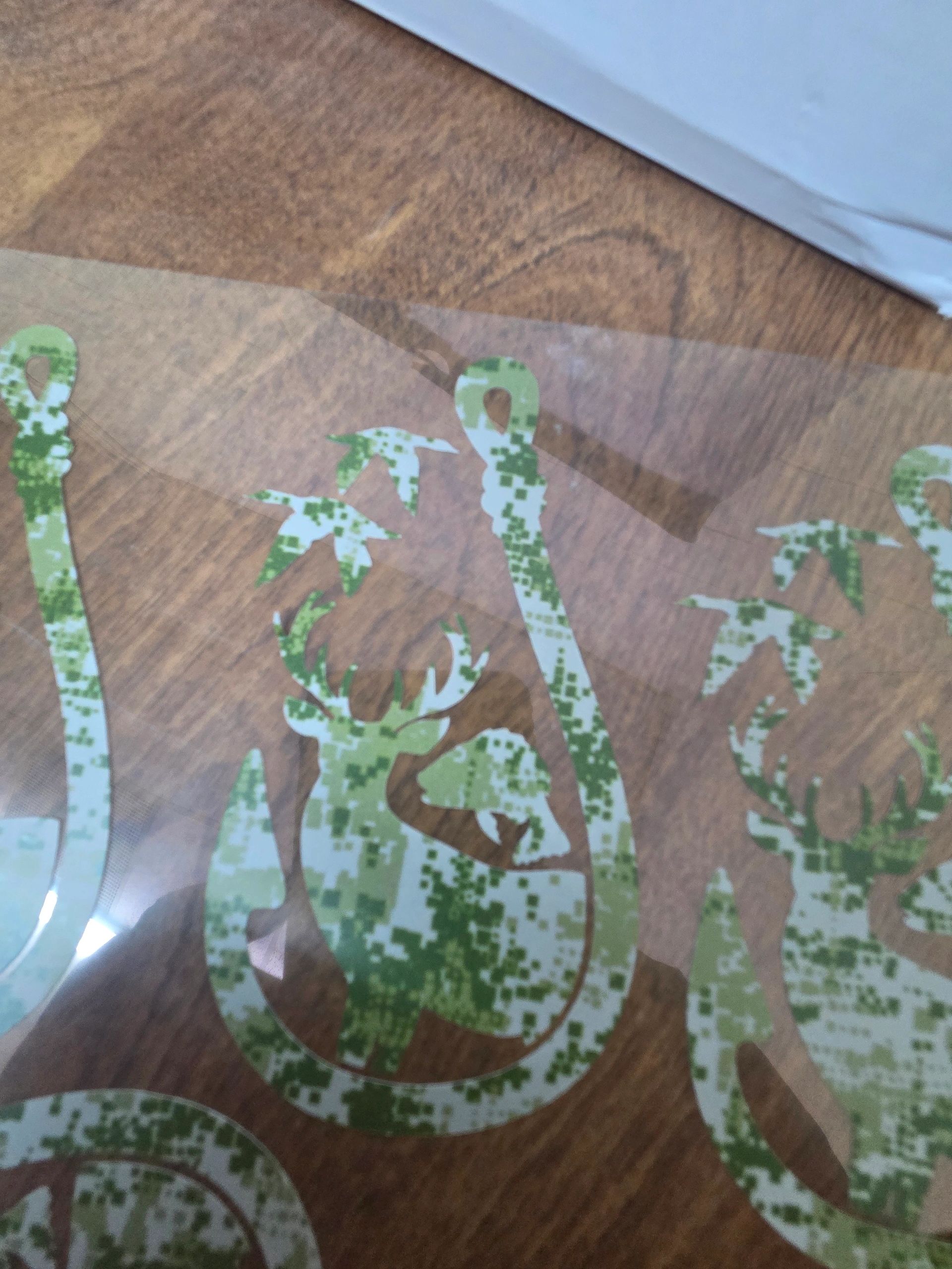 Camouflage fishing hook decal with deer, birds, and fish design.