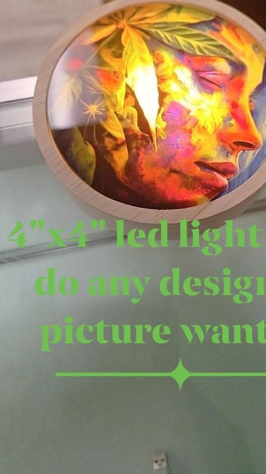 A vibrant 4x4 LED light featuring a colorful face design with leaves.