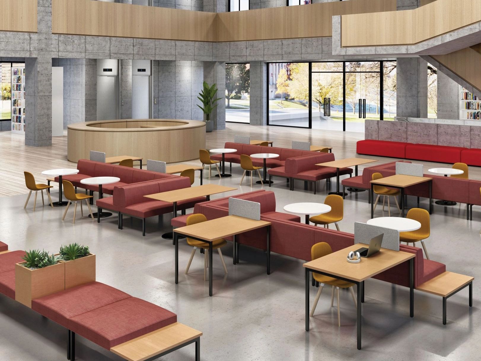 Modern co-working space with red sofas, wooden tables, and large windows.