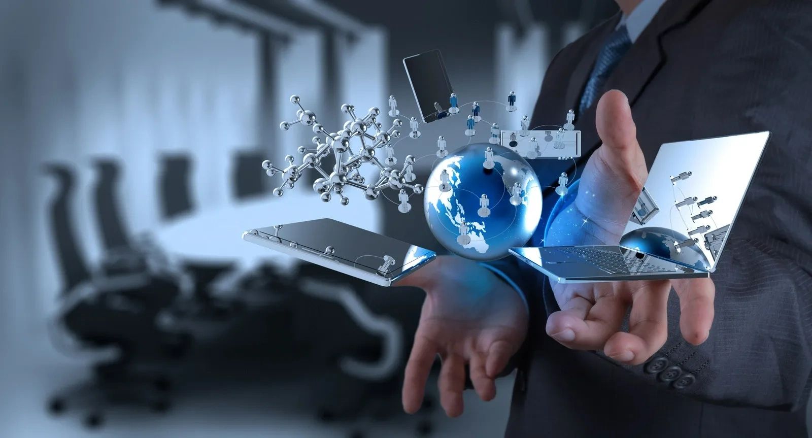 Businessman holding holographic digital network with globe and technology icons.
