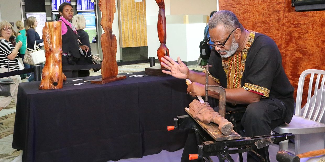 A man sitting and carving wood