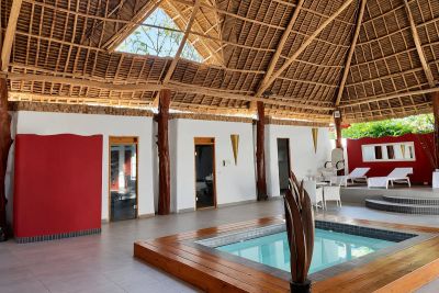 Jacuzzi beneath a thatched roof at Kitam Spa & Massage in Nungwi, Zanzibar.
