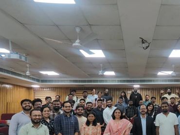 A large group of people posing for a photo indoors.