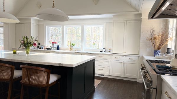 Modern kitchen with white cabinets and a large island.