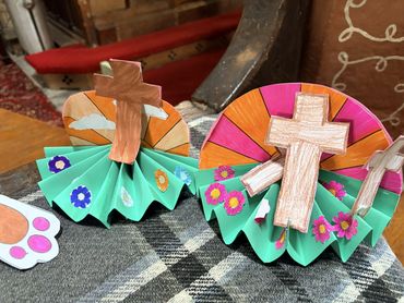 Handmade paper crafts featuring crosses and colorful decorations.