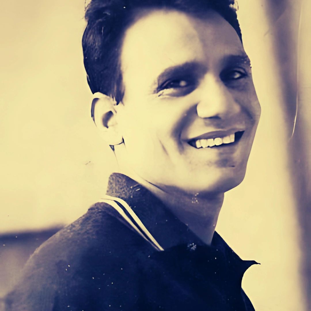 Smiling man in a close-up portrait with a vintage filter.