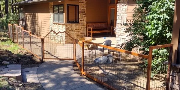 Unique custom metal front fence, with landscape inspired custom gate. 