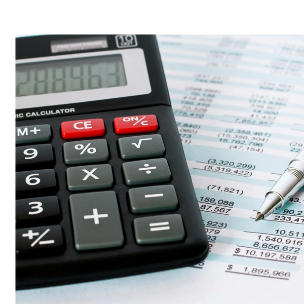 Calculator and pen on financial document with numbers and calculations.