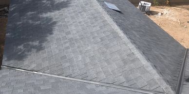 Gray shingled roof under sunlight.