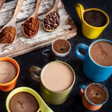 Coffee options displayed on a table - roasted beans, ground coffee, and hot brewed coffee in cups