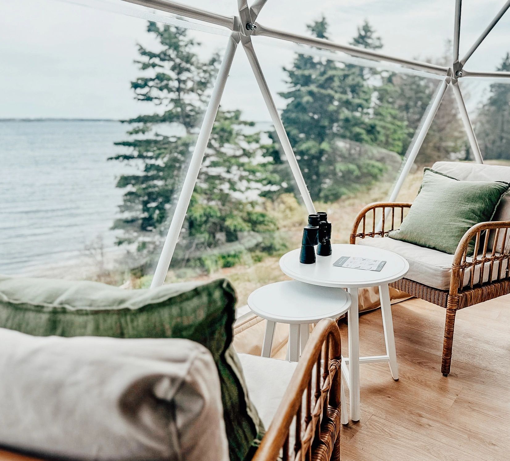 Sitting area with two chairs and coffee table in Nova Scotia glamping dome with beautiful ocean view