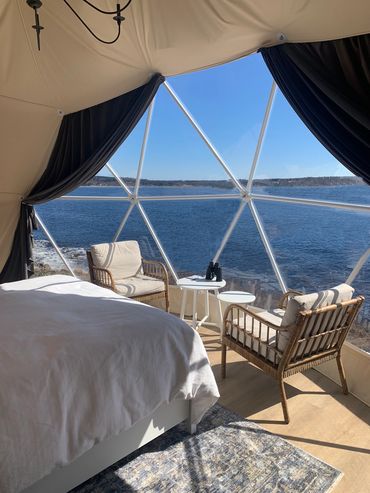 nova scotia dome bedroom and seating area on sunny day overlooking blue ocean