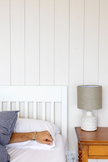 nova scotia dome with shiplap, bed, couple, nightstand and lamp