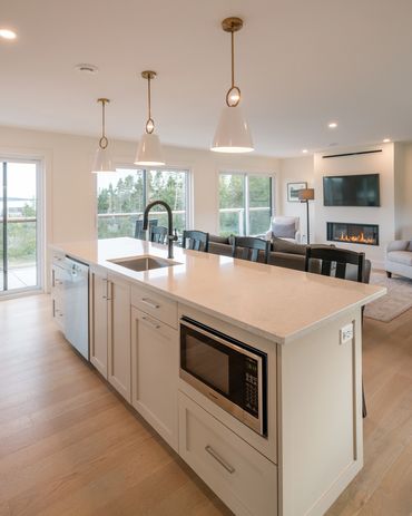 nova scotia cottage kitchen with open concept layout leading into living and dining room.