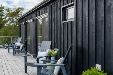 nova scotia cottage exterior showing board and batten exterior stained black.