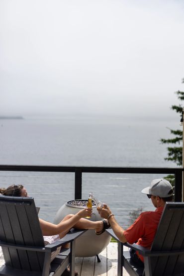 Nova scotia glamping dome deck with couple enjoying view of ocean