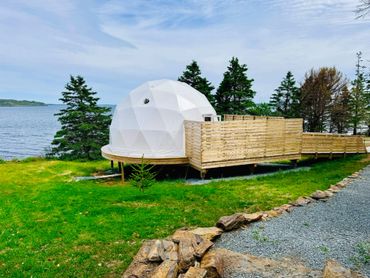 NS Dome exterior with private deck, grass, path and ocean