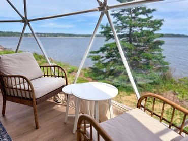 NS Dome sitting area with chairs, coffee table and ocean view