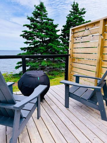 NS Dome private deck with muskoka chairs, fire table and ocean