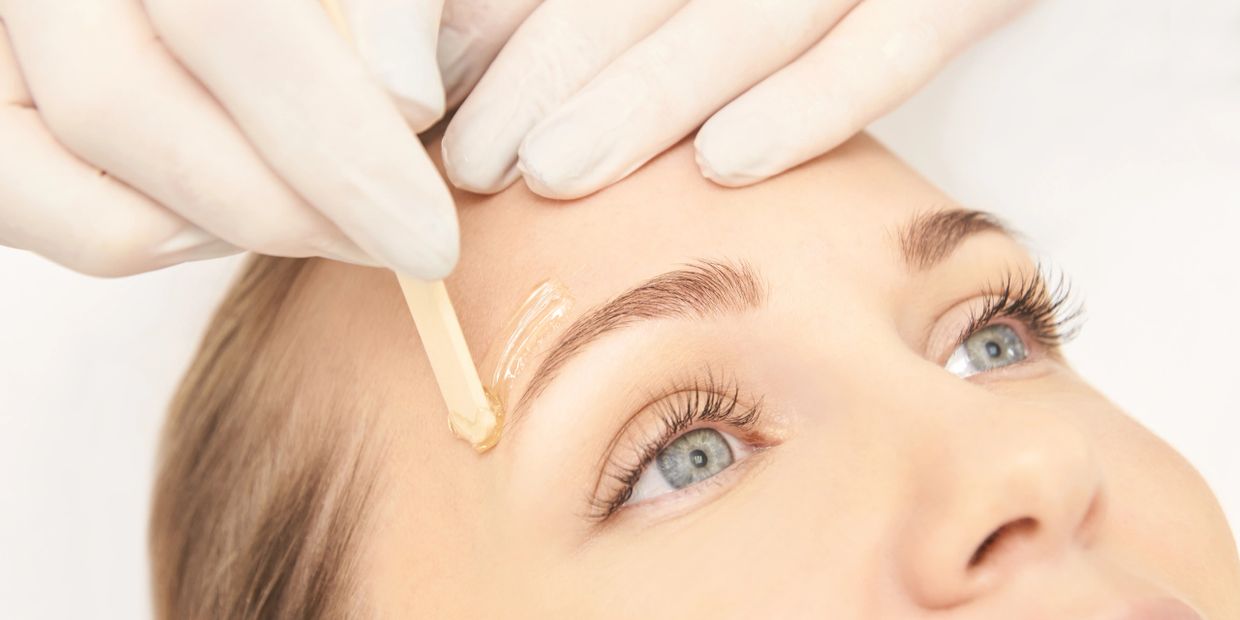 Woman getting her eye brows waxed