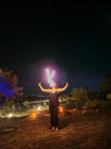 Person performing fire breathing at night outdoors.