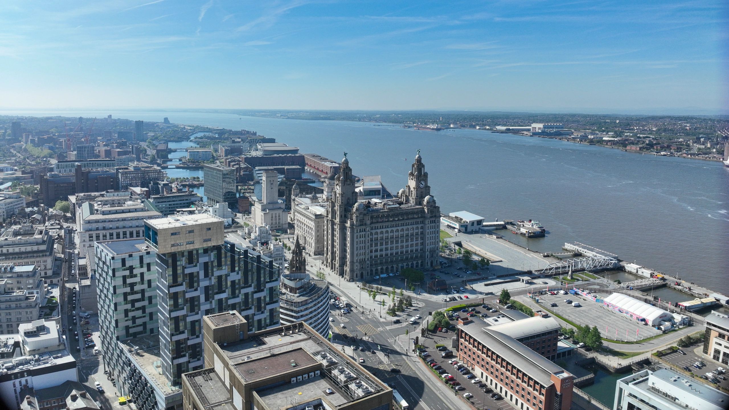 Aerial view of Liverpool waterfront with iconic Royal Liver Building along the River Mersey.