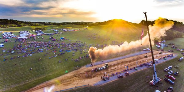 Aerial photo of the tractor pull with a sunset back drop. 
