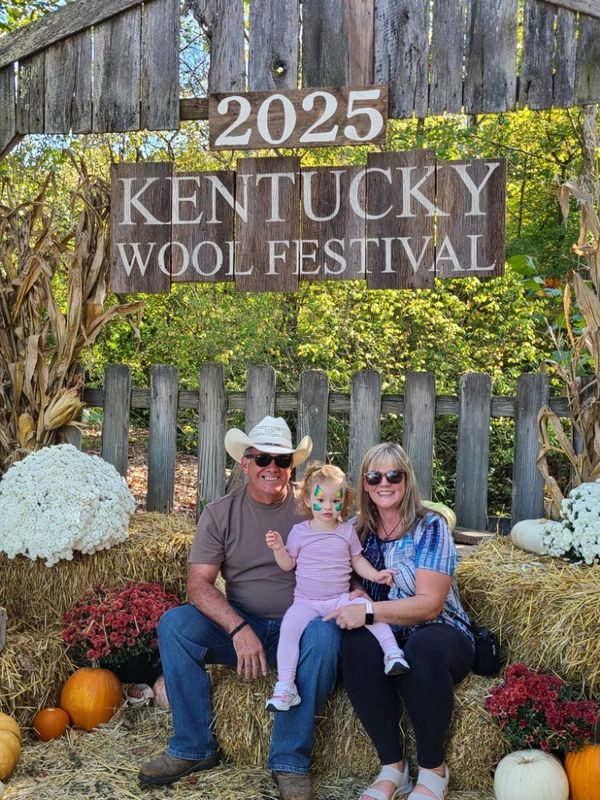 Family enjoying the 2025 Kentucky Wool Festival with fall decorations.