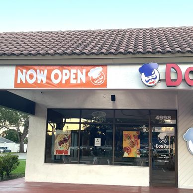 outdoor now open banner hanging from storefront 