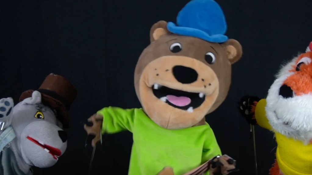 Still Of Billy the Bear Playing the Guitar and Singing "Hairy Kind of Guy" Between His Pals