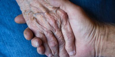Two hands holding each other gently.