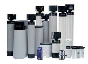 Various water softener and filtration system units arranged together.